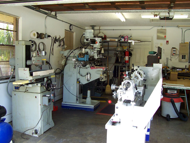 A well-equipped workshop with lathes, grinders, and metalworking equipment, organized and clean.