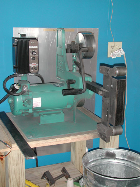 Heavy-duty Bader III Grinder on wooden platform in an industrial setting.