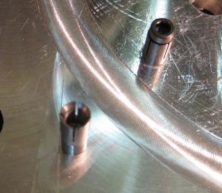 Two cylindrical metal parts with threaded ends, likely a fixture or tool.