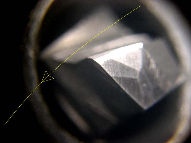 Diamond-coated cutting tool with metallic body and angled position showcasing its diamond-coated tip.