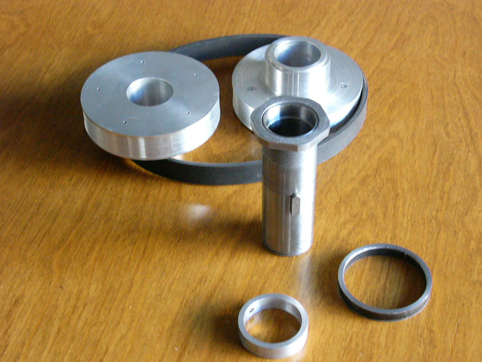 Silver metal parts on a wooden surface.