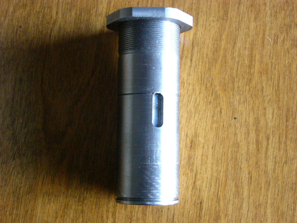 Metal object with threaded top and small rectangular hole.