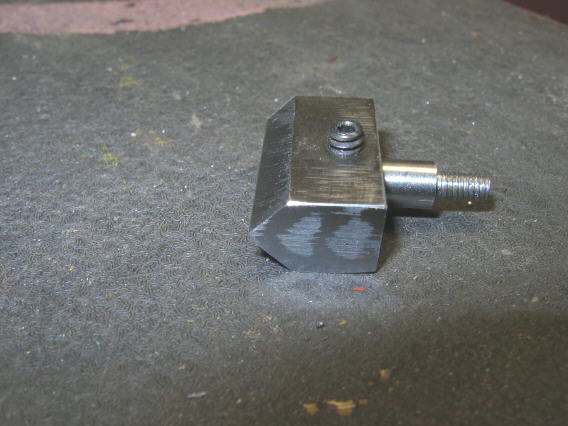 Small metal component with threaded end and square base.