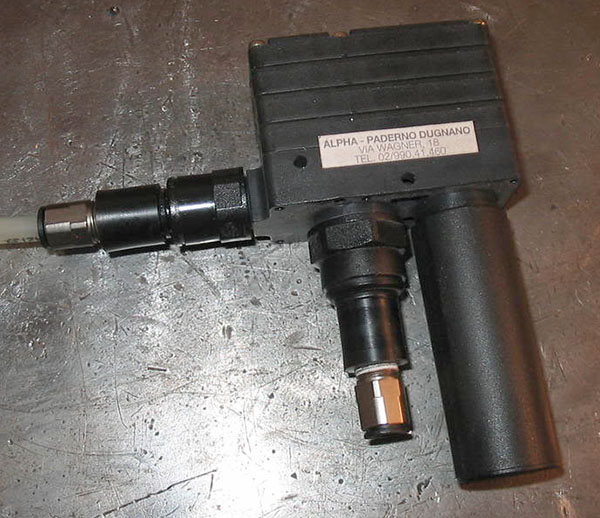 Handheld machinist tool with long handle, cylindrical body, and small nozzle.