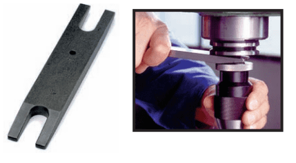 Gray metal tool with two prongs and close-up photo of a cylindrical object.