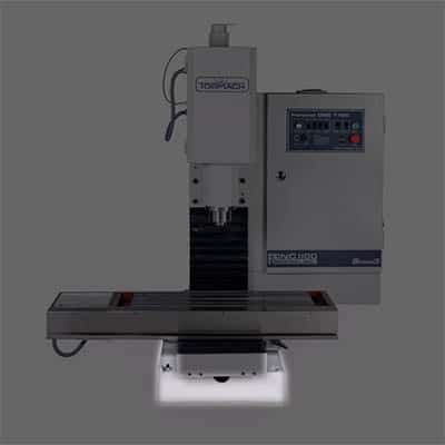 Industrial milling machine with large table and metal frame.