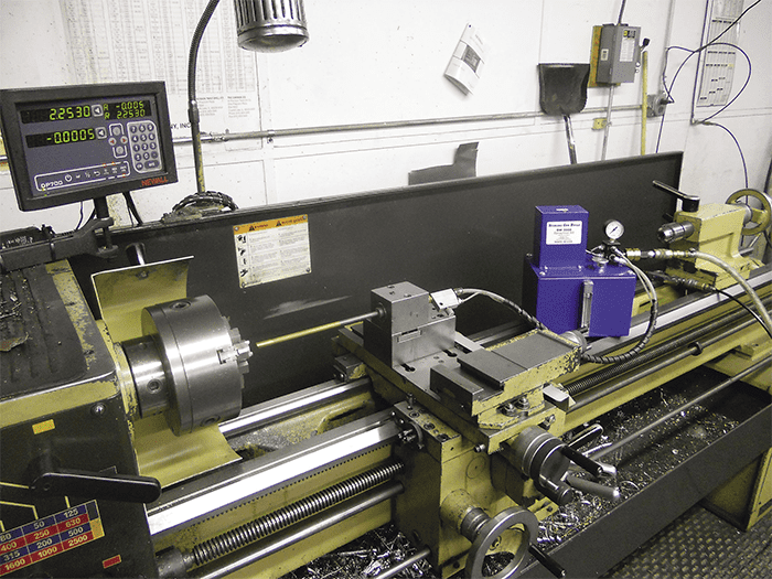 Large lathe in metal fabrication or CNC machine setting.