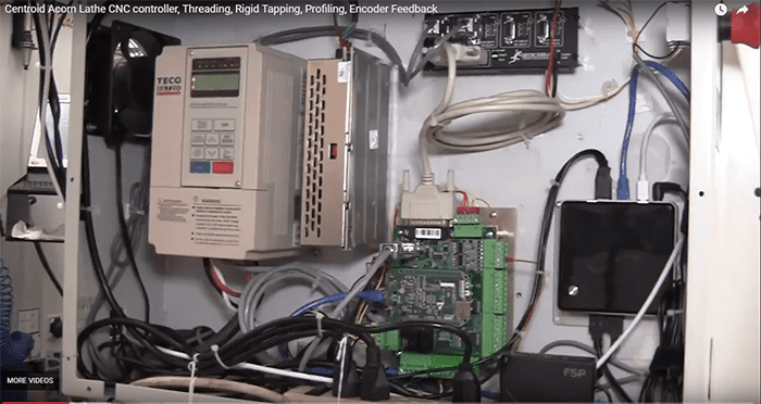 Beige control panel with electronic components, wires, and a green circuit board.