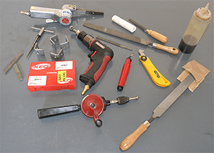 Metal fabrication tools, drill, saw, and handheld devices.