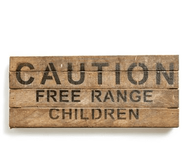 Wooden sign with "CAUTION FREE RANGE CHILDREN" text.