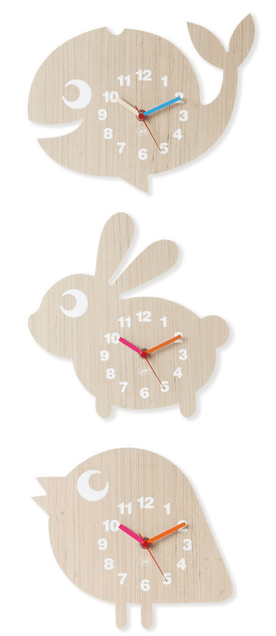 Four wooden wall clocks in the shape of whales or fish with unique color schemes and white numbers.