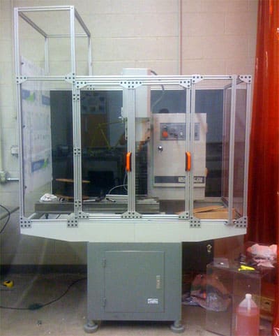 Large metal enclosure with glass panels made of aluminum or metallic material.