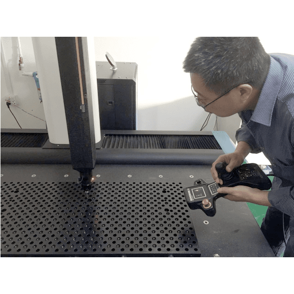 Machining equipment and technician adjusting settings.