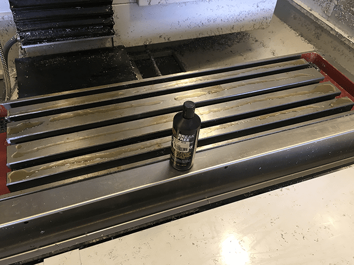 Black lubricant bottle on top of metal tool.