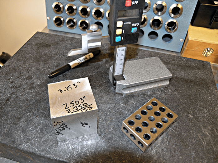 Measuring tools on a workbench, featuring caliper, micrometer, and digital readout.
