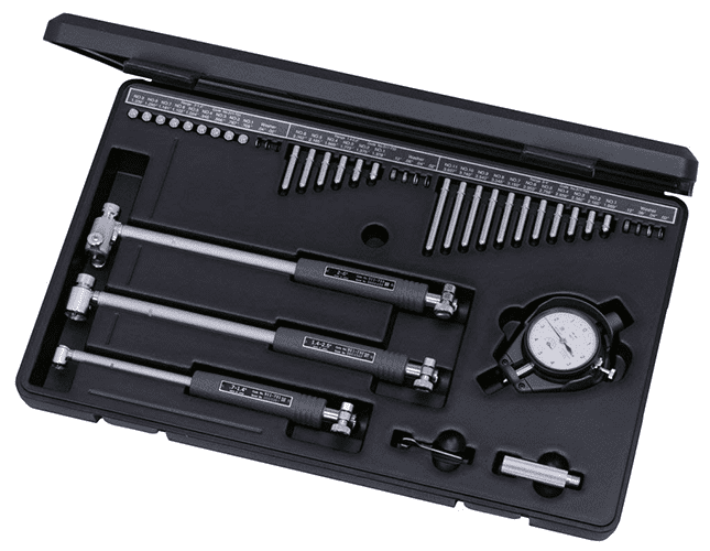 A comprehensive tool set for metrology or precision measurement, featuring a dial test indicator, straight-edge rulers, vernier caliper, micrometer, and measuring pins.