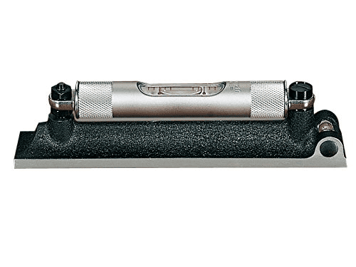 Silver and black metal device with two knobs and central opening.