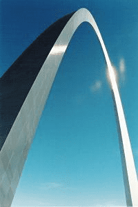 Shiny metal arch landmark against a blue sky.