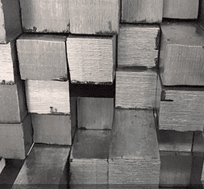 Stacked wood blocks in a grid pattern, with some blocks slightly askew.