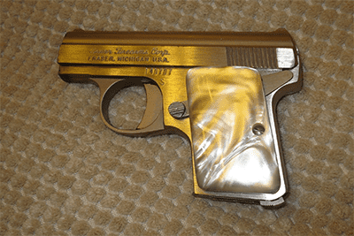 Gold-colored handgun with engraved "Taurus 45" text.