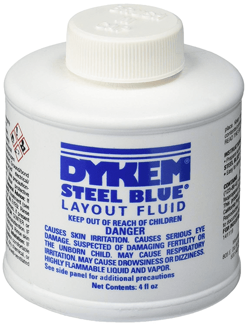 A close-up of a Dykem Steel Blue Layout Fluid bottle label.