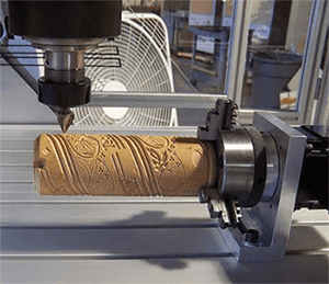 Machining spindle with cylindrical object and intricate patterns.