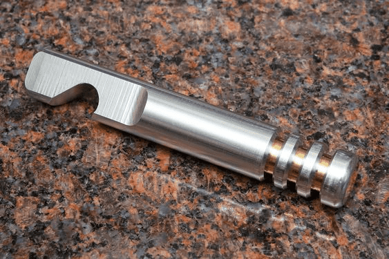 Cylindrical metal object with flat end and threaded base.