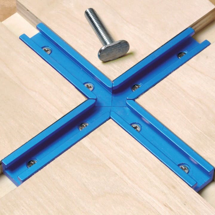 Blue X-shaped tool with threaded rod, wooden base, and silver bolt.