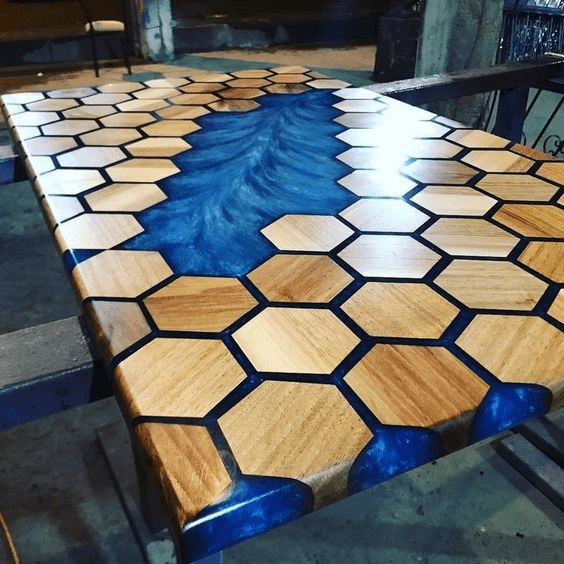 Unique hexagonal wood table with blue resin inlays.
