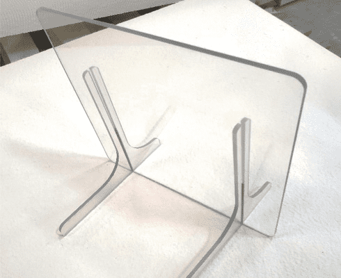 Clear, rectangular plastic or glass object with rounded corners and parallel grooves.
