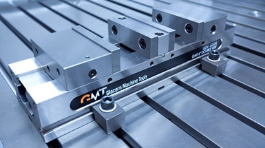 Stainless steel double vice with GMT logo, closed jaws, and two holes.