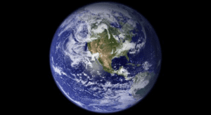 High-resolution image of the Earth from space, with blue hue and atmospheric layers.