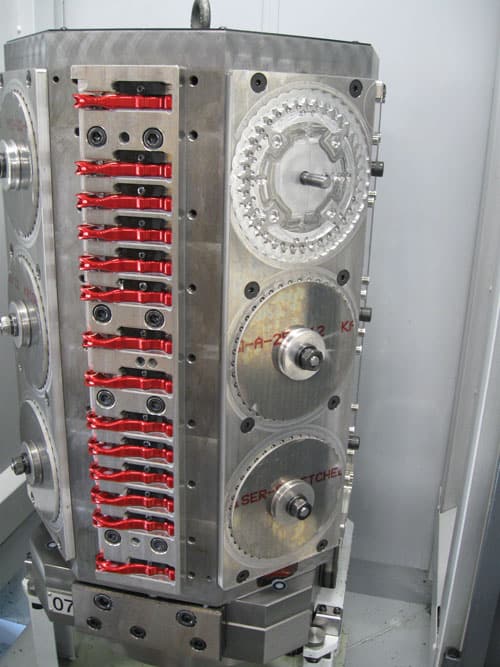 Metal tombstone with red levers and circular components.