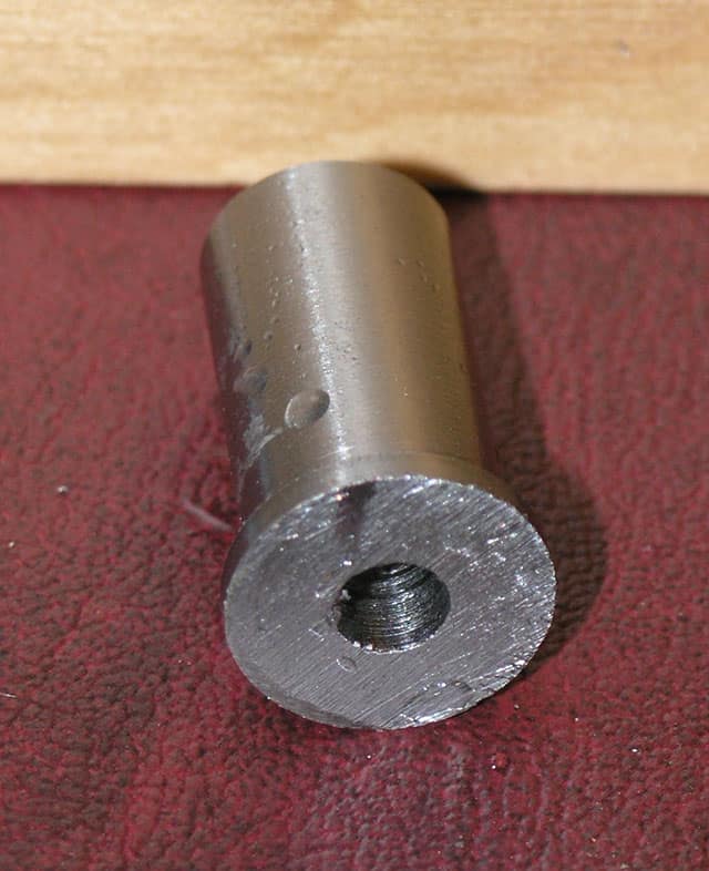 Cylindrical metal object with threaded central hole.