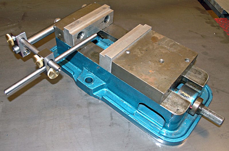 Large metal vise with blue base and metal jaws.