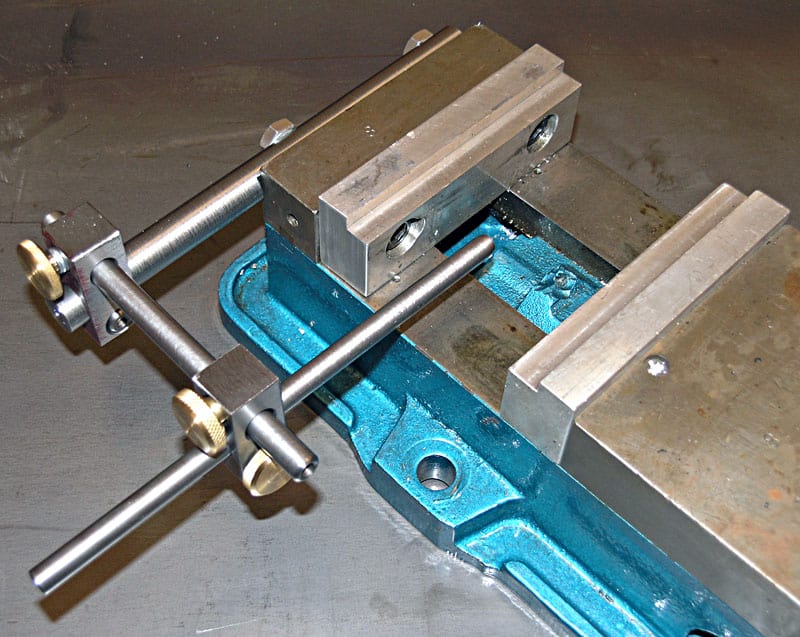 Metal vise with adjustable jaws and blue and silver components.