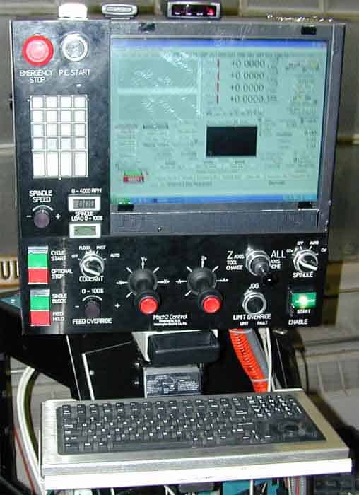Bridgeport milling machine control panel with screen and various controls.