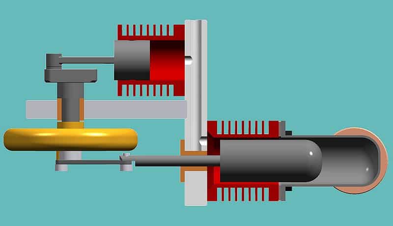 A 3D CAD model of a mechanical device with a cylindrical body, yellow ring and red components.