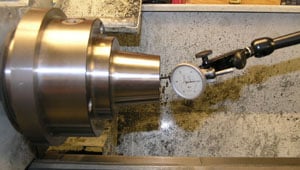 Stainless steel collet chuck held in three-jaw CNC machine chuck.