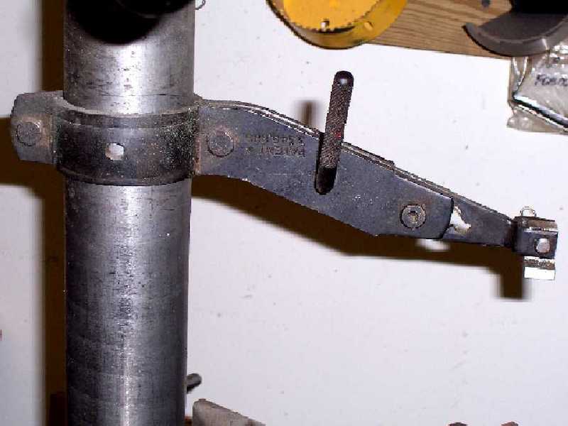 Metal clamp with side handle and adjustable mechanism.