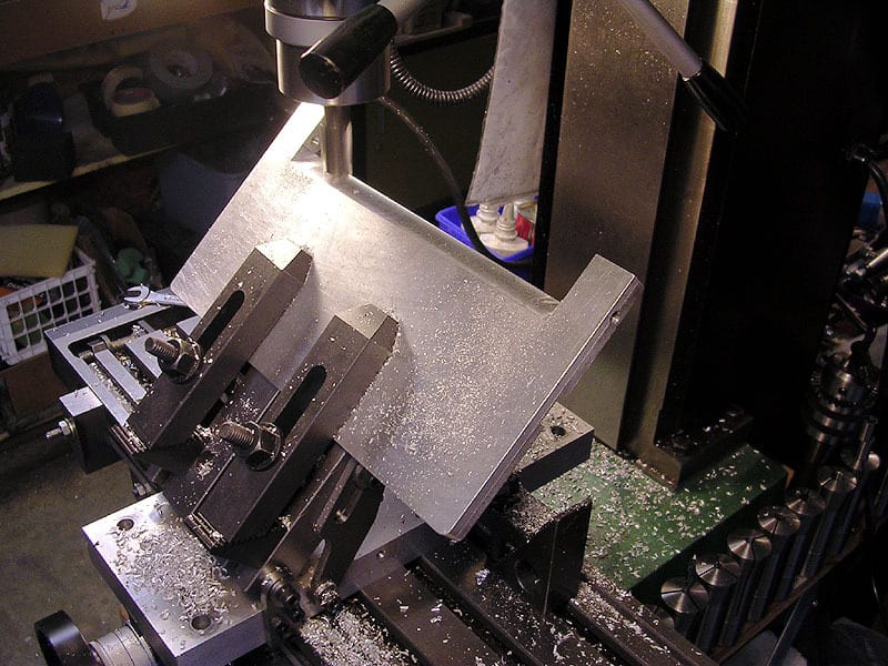 Industrial machine with gear setup and metal shavings.