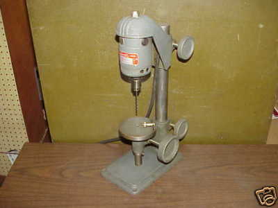 A Dumore Sens Press drill press in a workshop or showroom setting.