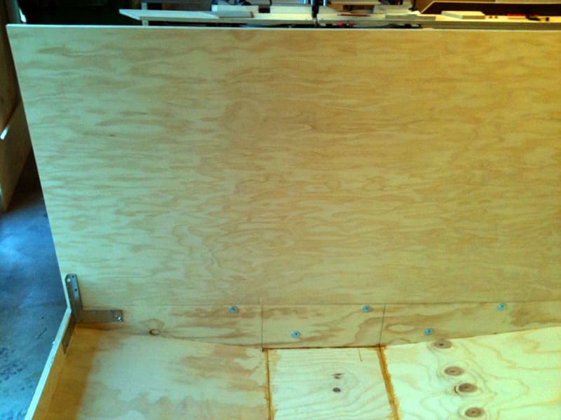 Wooden workbench with flat surface made from multiple plywood or MDF pieces.