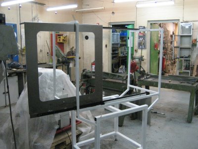 Large metal frame with rounded corners, possibly steel or aluminum, featuring visible rust spots.