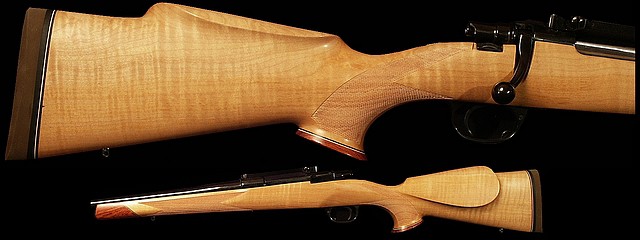 Rifle with light-colored wood stock on dark background.