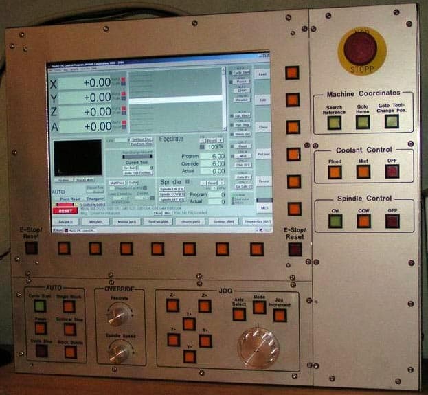 Large industrial control panel with screen display and various controls.