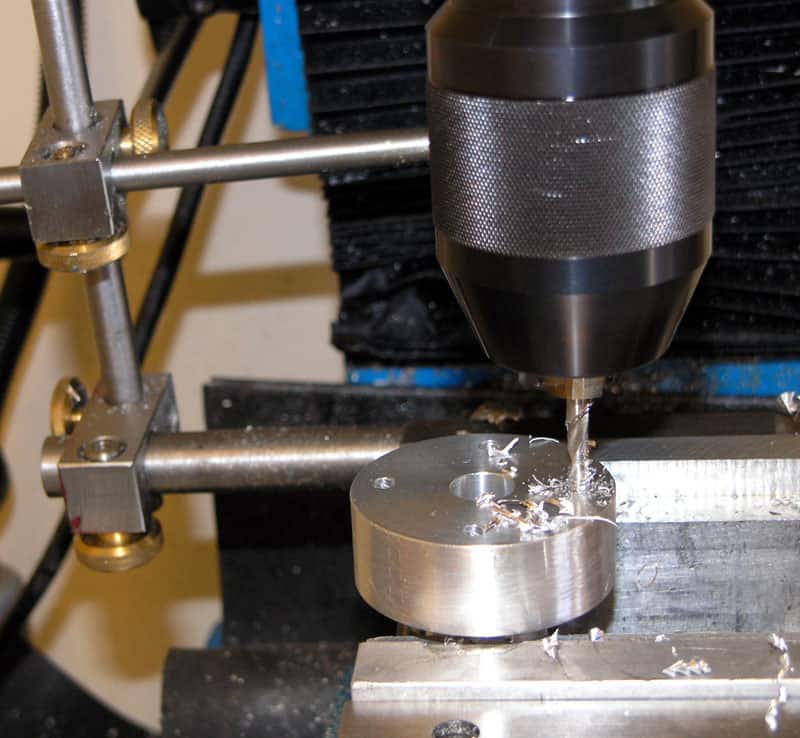 Milling machine with cutting tool in close-up view.