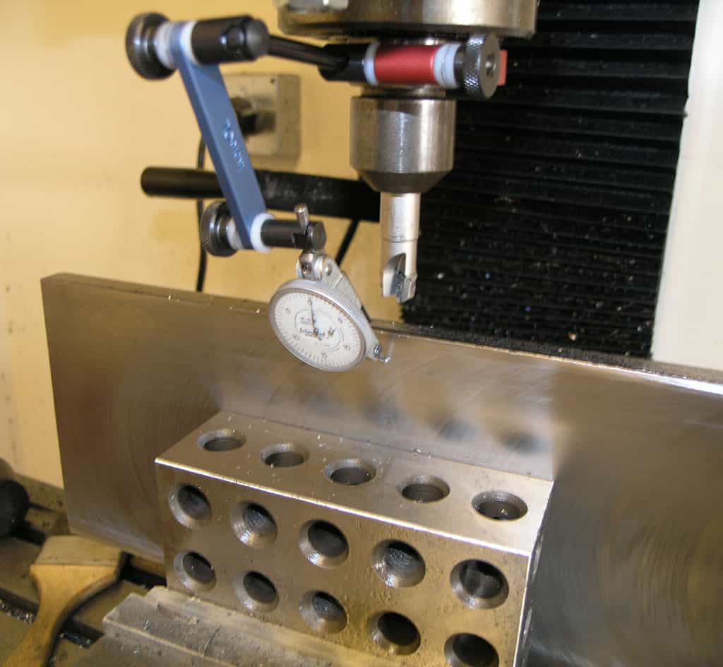 Precision tool on metal surface with holes, for machining and metrology.