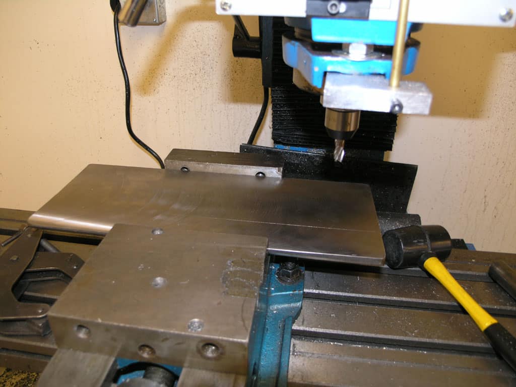 Metalworking machine tool with flat surface and milling/drilling attachments.