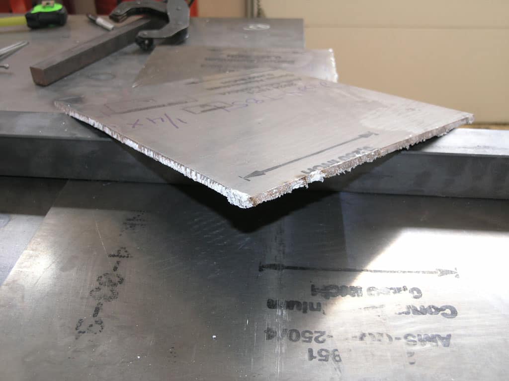 Rough-cut metal parts in a workshop or factory setting.